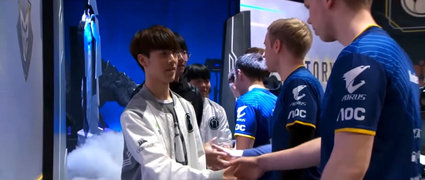 TheShy in the white Invictus Gaming jacket shaking hands with G2 players after the 2018 Worlds semifinal